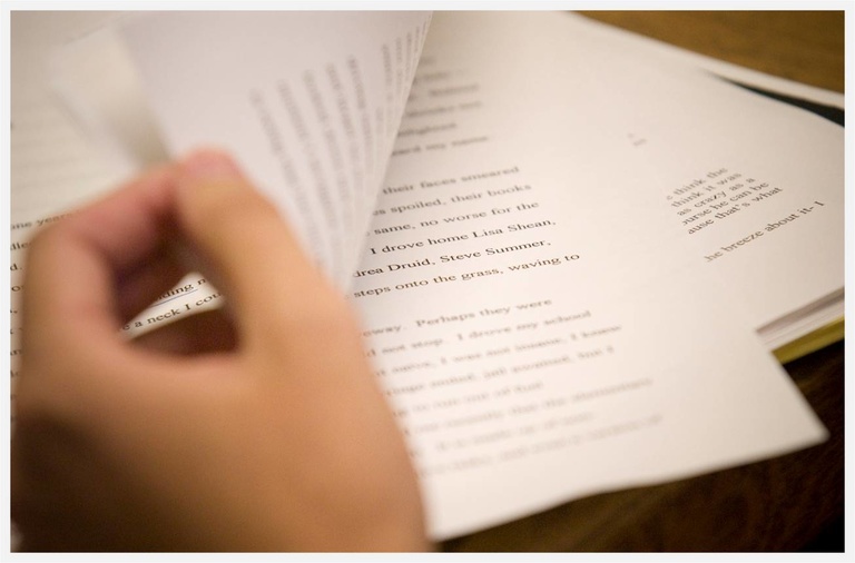 hand turning page of manuscript