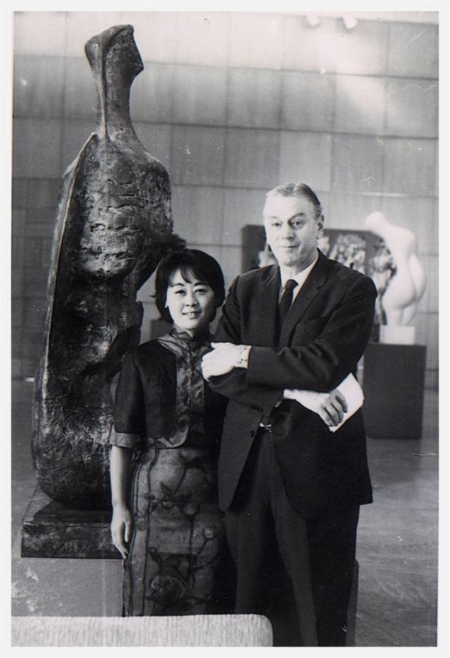 a black and white photo of a couple at a museum
