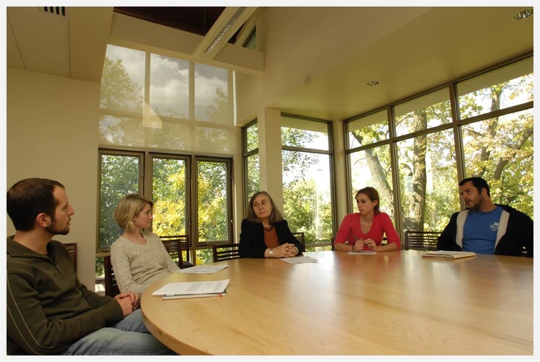 students in a room with large bright windows