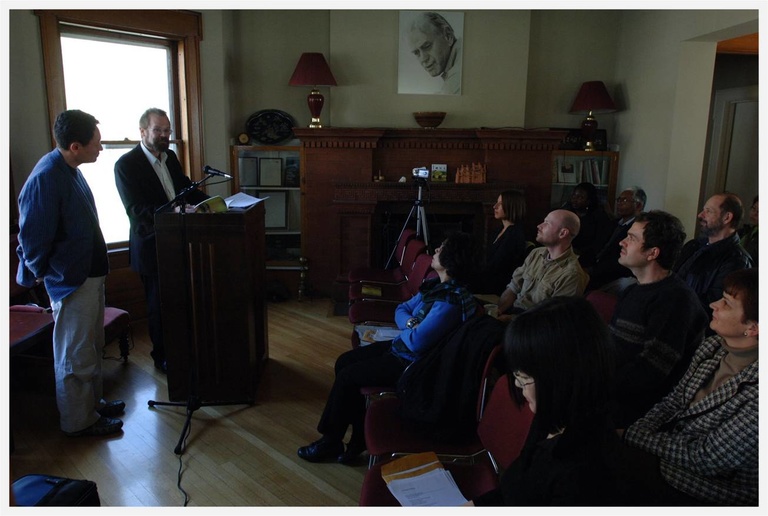 an audience listening to an author read