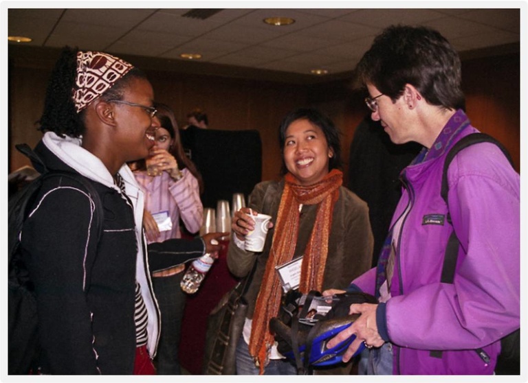 three friends meeting at a conference