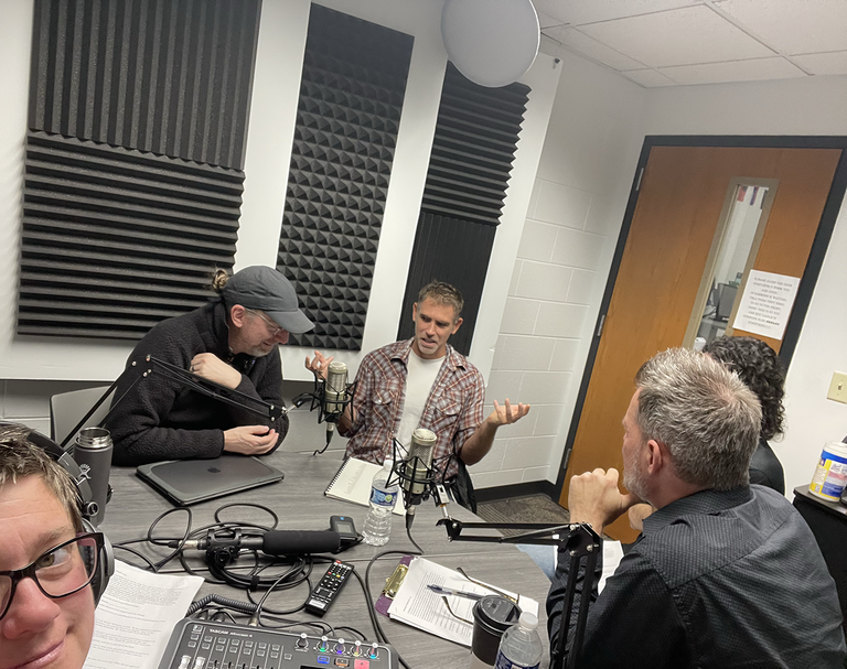 people talking in podcast room