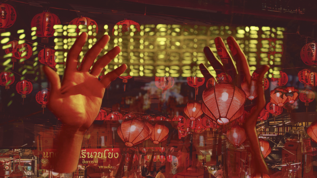 Photo of red lanterns with hands.