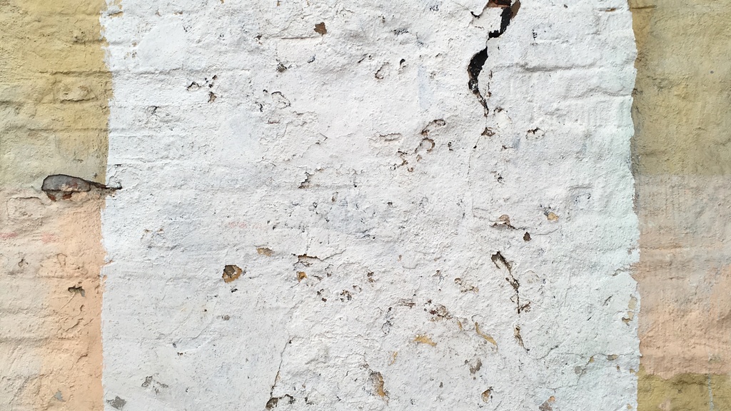 Photo of a white square on a painted brick building.
