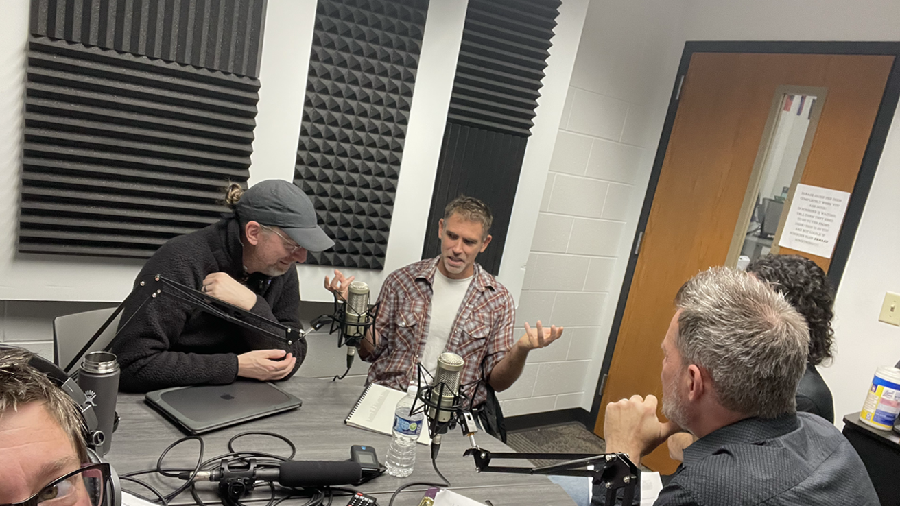 people talking in podcast room
